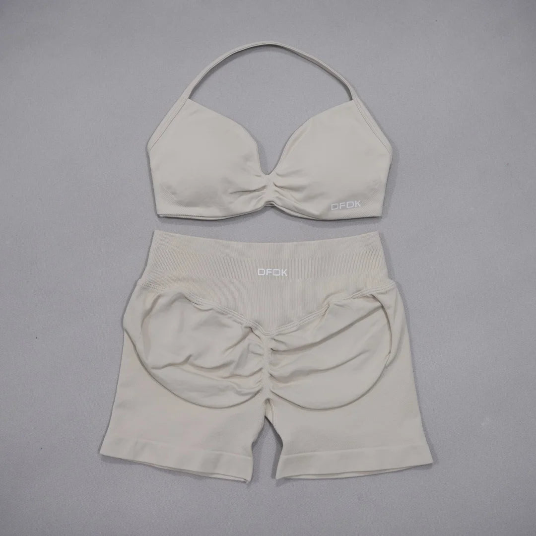Brown women's 2-piece sports set by DFDK, including a sports bra and matching leggings, designed for active wear.