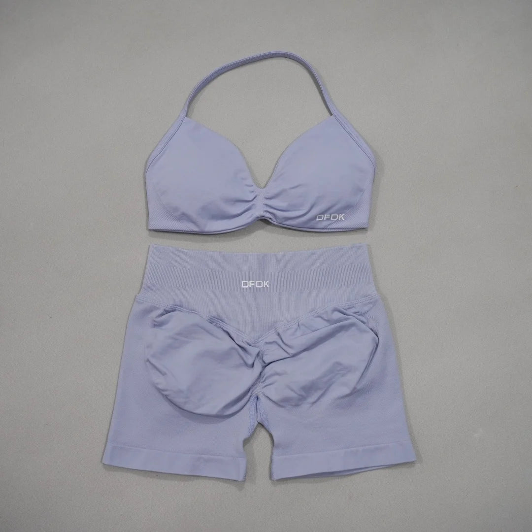 Brown women's 2-piece sports set with bra and shorts from Corporación Turística, designed for active wear and comfort.