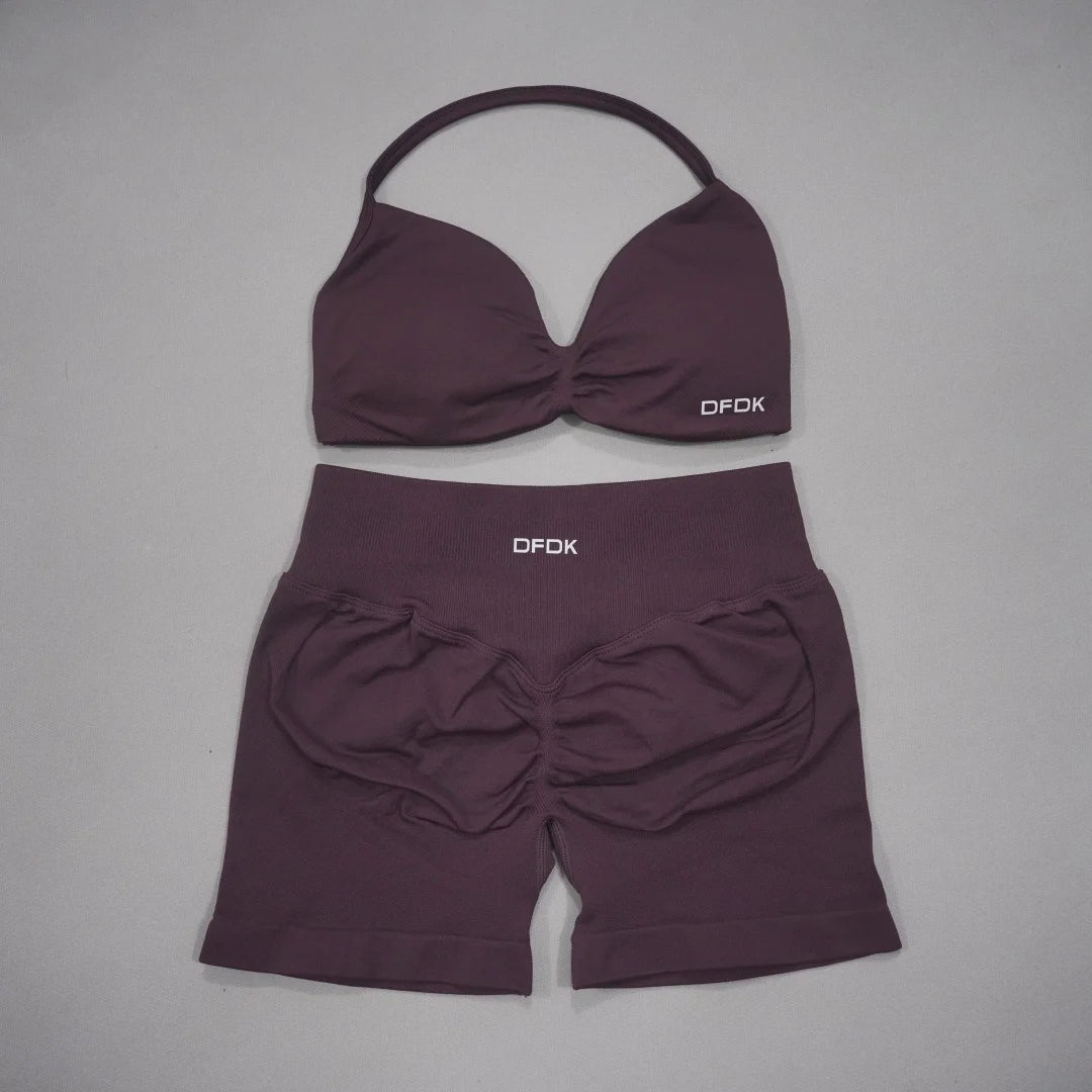 Brown women's 2-piece sports set with DFDK sports bra and matching shorts, designed for active wear by Corporación Turística.