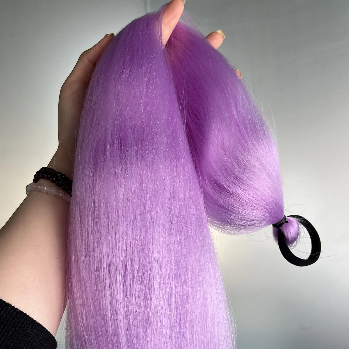 Purple synthetic ponytail extension with band, 26-28 inches long, designed for easy attachment and natural look.