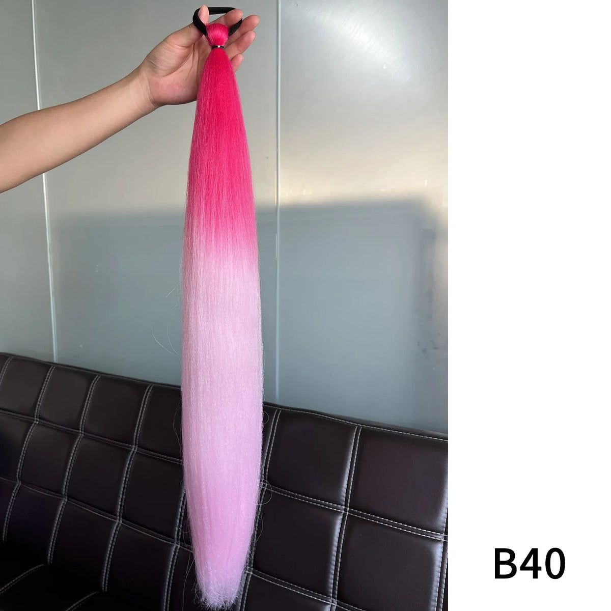 Synthetic purple ponytail extension with band, 26-28 inches long, by Corporación Turística, shown attached and styled.