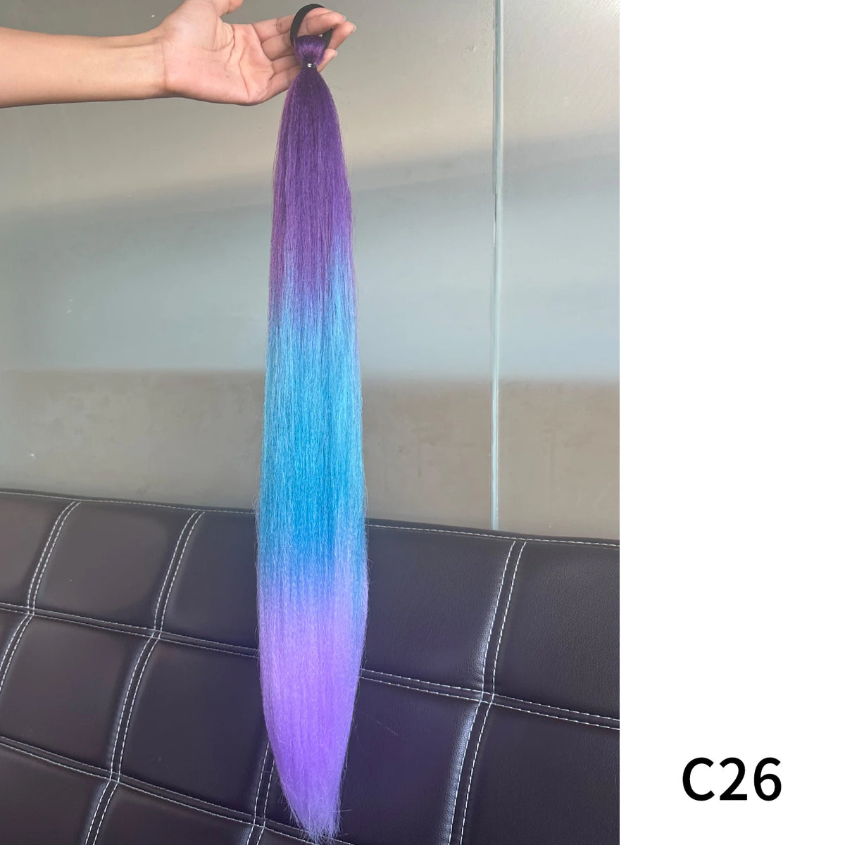Synthetic purple hair extension with band, 26-28 inches long, by Corporación Turística, styled as a ponytail extension.