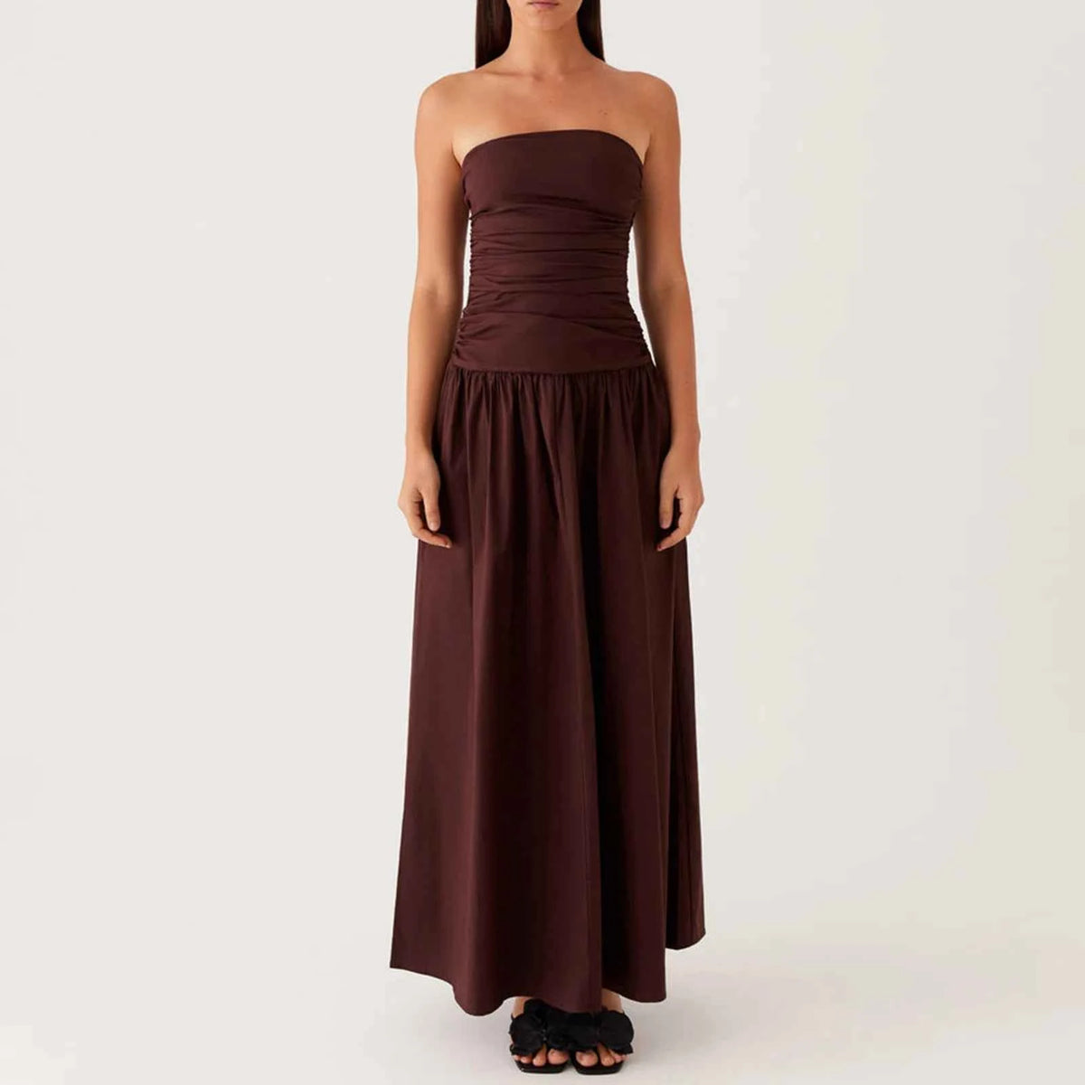 Elegant long sleeveless women's dress in khaki from Corporación Turística, featuring a flowing design and stylish V-neck.
