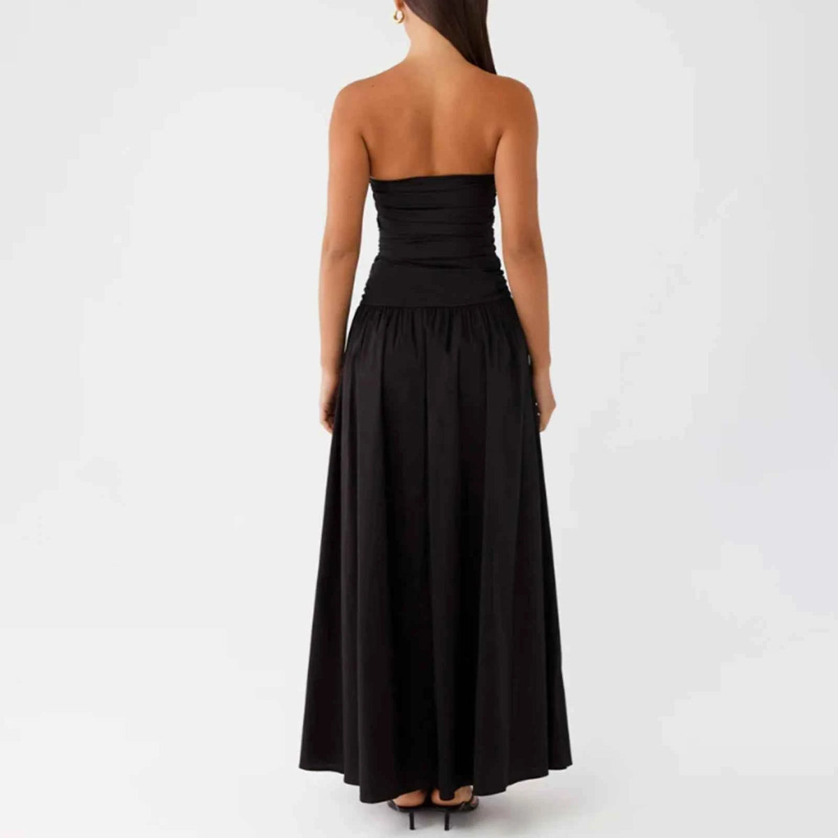 Elegant long beige strapless dress for women, featuring a flowing design, ideal for formal occasions.