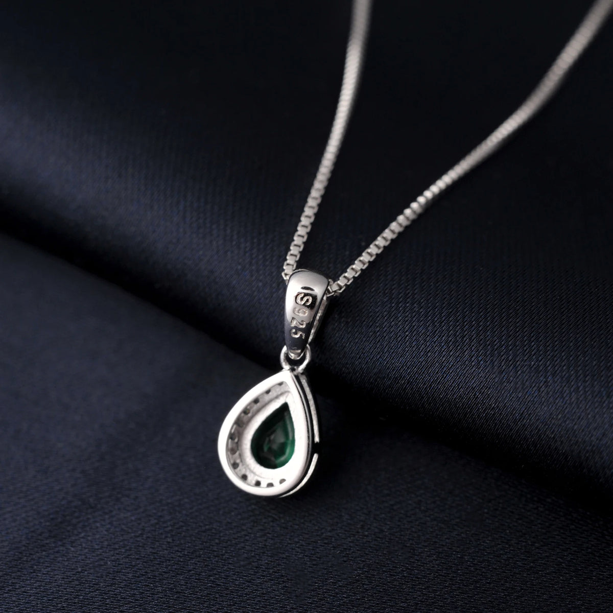 Sterling silver 925 necklace with emerald pendant, featuring a shiny rhodium-plated finish, showcasing elegant jewelry design.