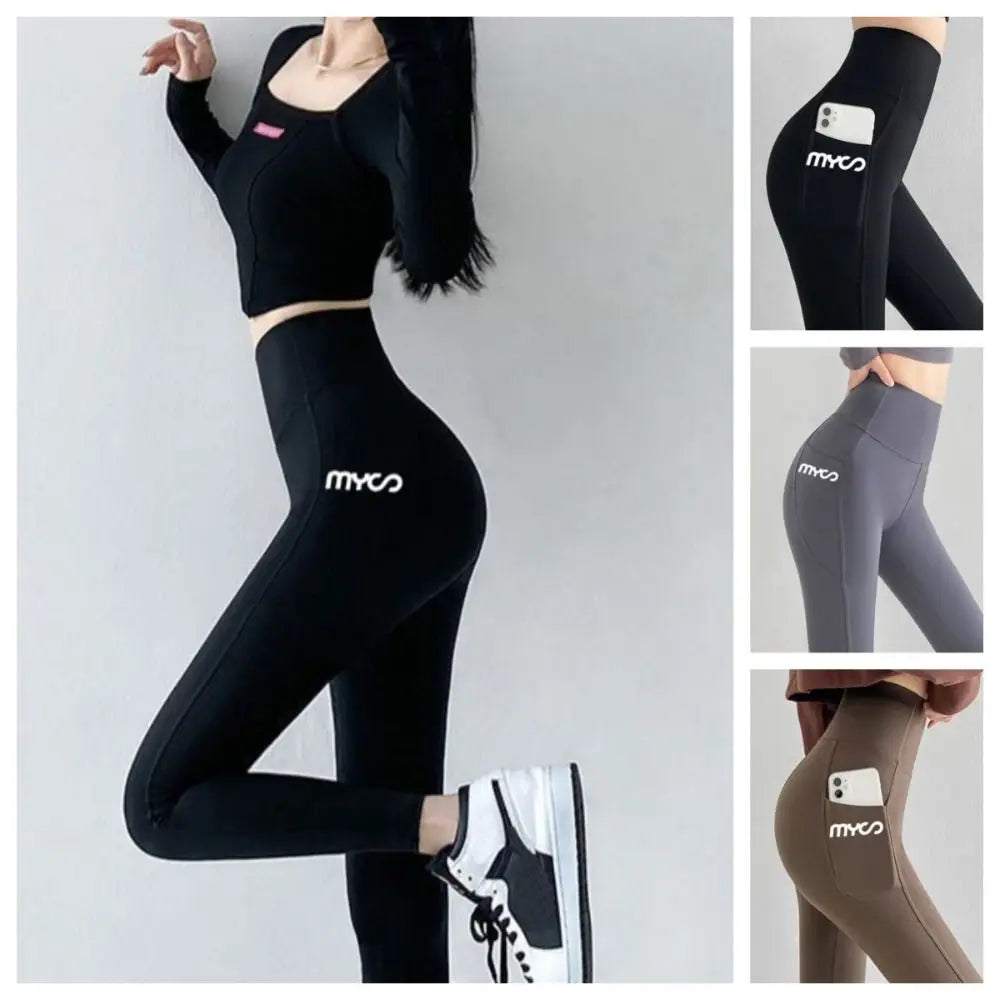 Seamless black women's leggings with a pocket, made by Corporación Turística, shown laid flat with smooth fabric and waistband.