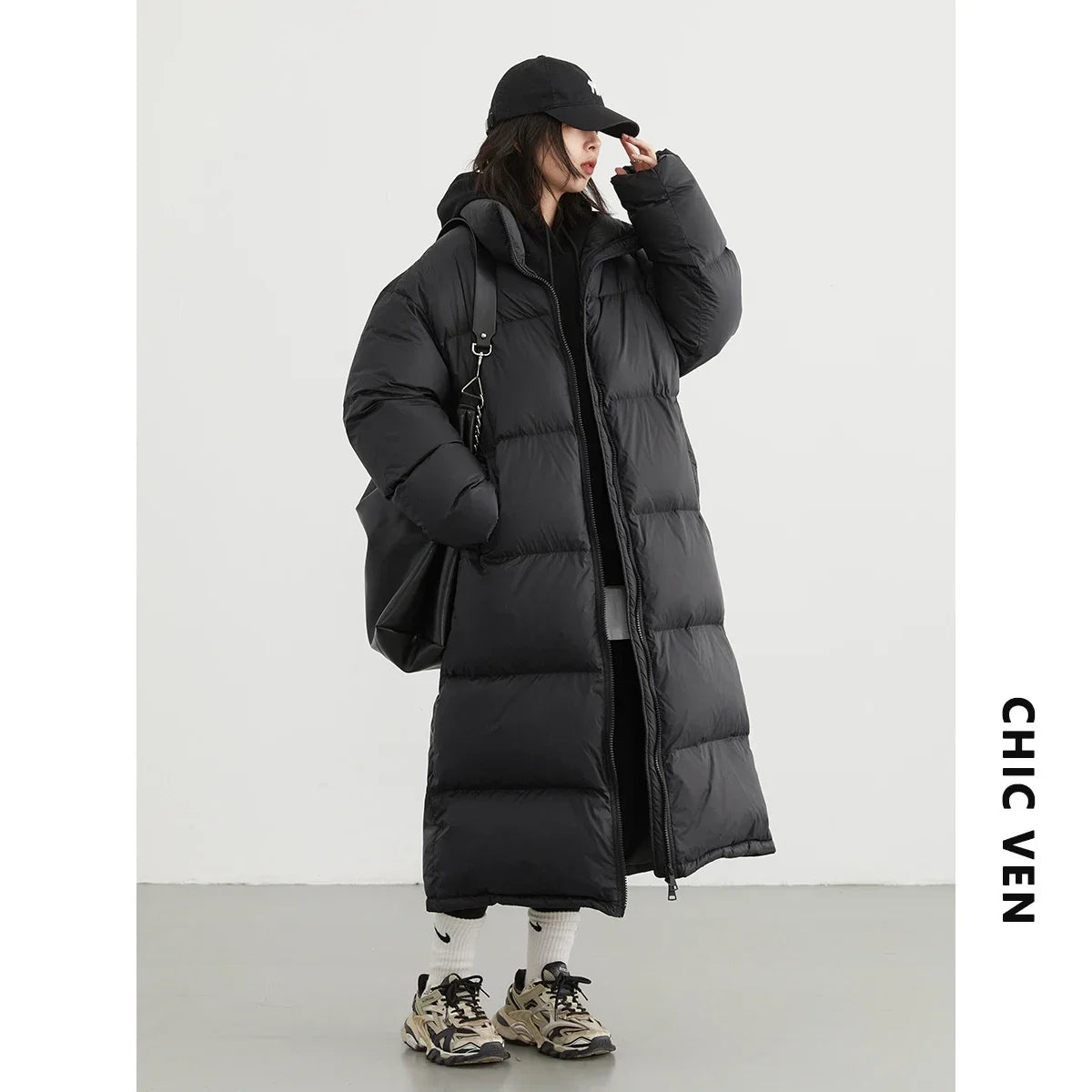 White women's duck down puffer coat by CHIC VEN, shown on a model, featuring a stylish collar and cozy design for cold weather.