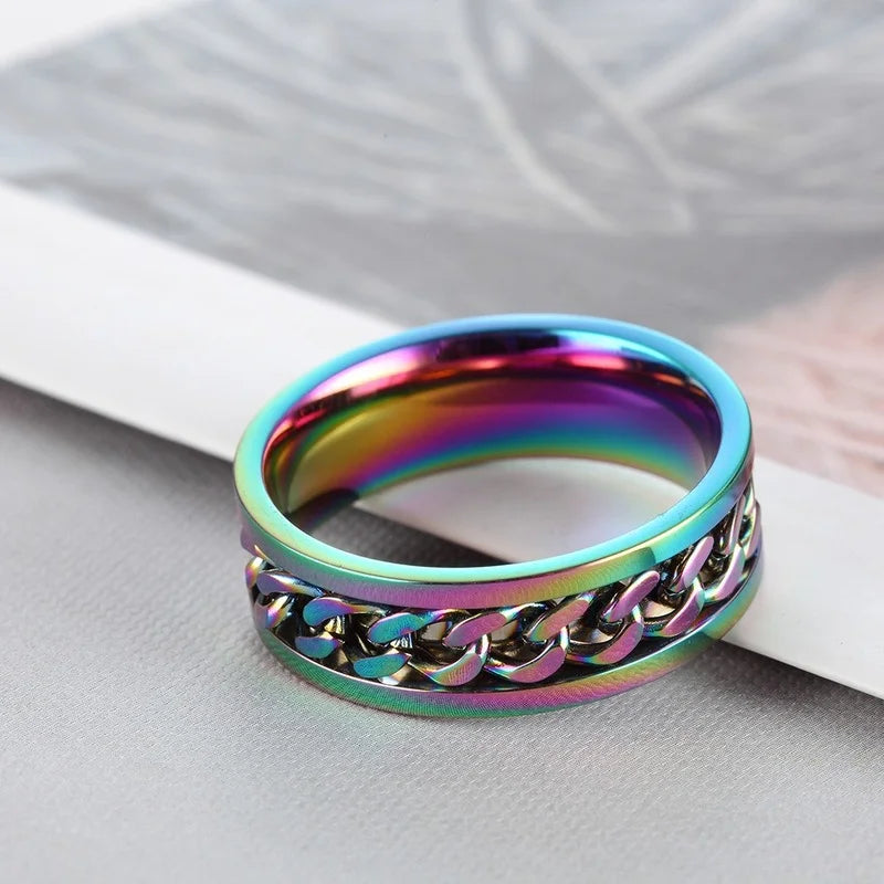 Titanium steel rotating chain rings for women, stylish jewelry from Corporación Turística, displayed in vibrant colors.