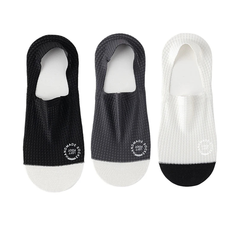 Three pairs of dark grey invisible men's socks from Corporación Turística, suitable for shoe sizes 37-44, shown folded and stacked.