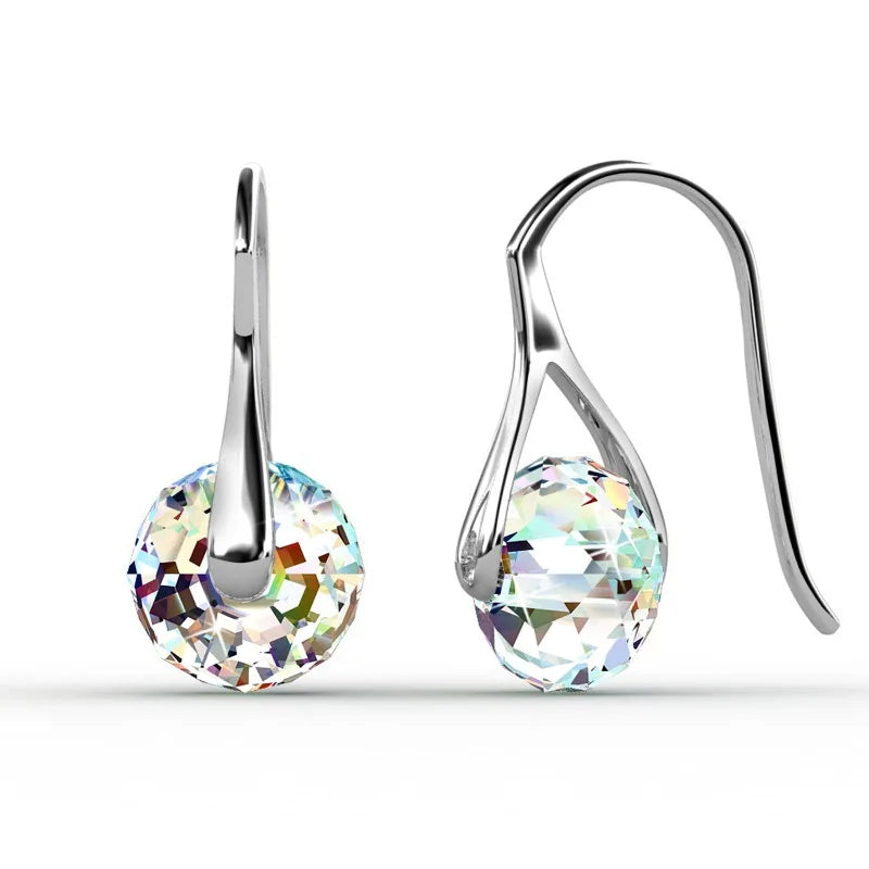 Elegant dangling earrings with round crystal beads by Corporación Turística, showcasing shiny, colorful crystal pendants.