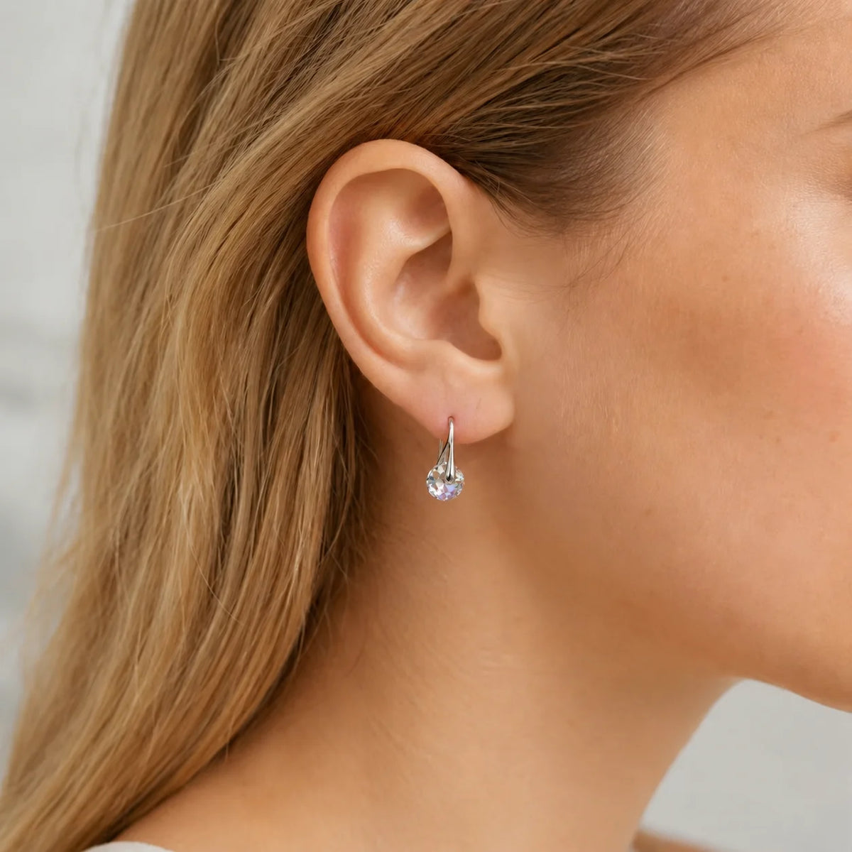 Elegant dangling earrings with round crystal beads, featuring a polished metal finish, from Corporación Turística.