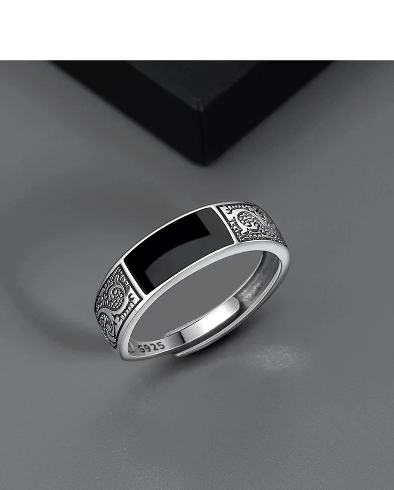 Sterling silver men's ring with a black gemstone, crafted by Corporación Turística, showcasing a sleek and bold design.