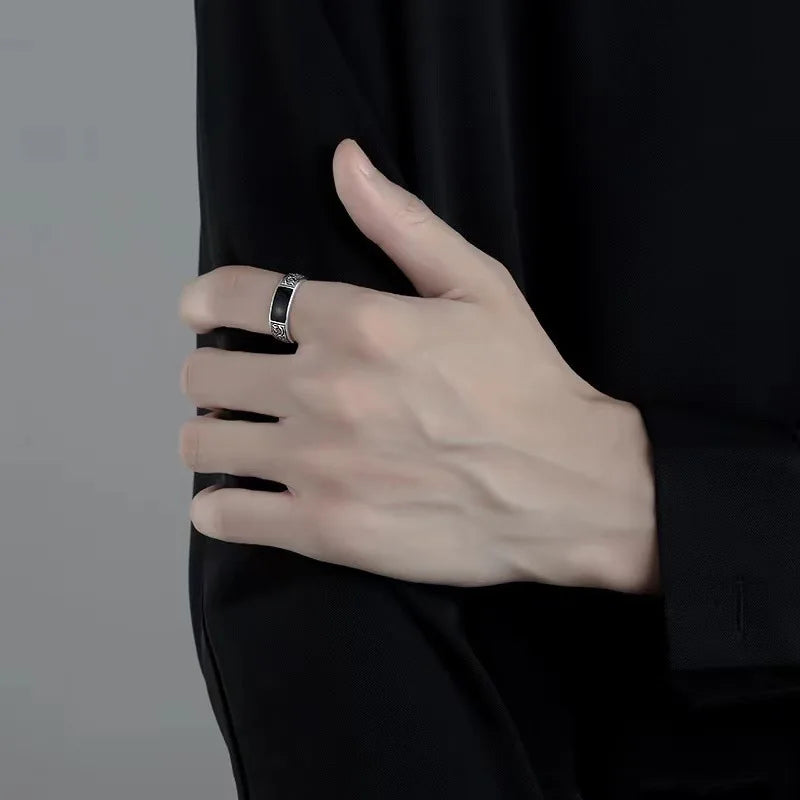 Sterling silver 925 men's ring with a black gemstone, featuring a sleek and stylish design.