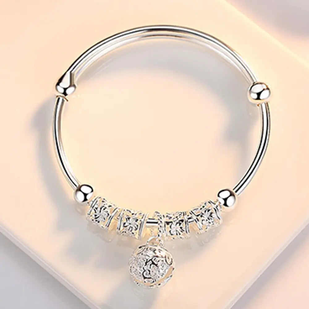 Silver 925 bracelet with hollow bells from Corporación Turística, featuring intricate metalwork and decorative charms.