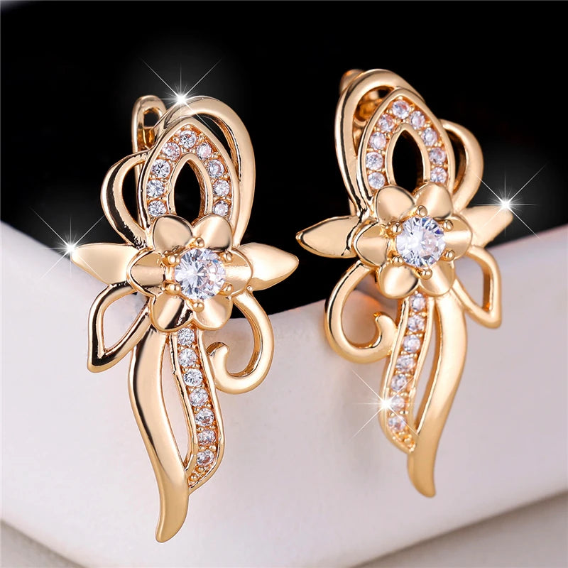 Silver hoop earrings with floral design and sparkling zircon stones, crafted by Corporación Turística.