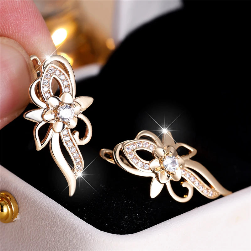 Silver hoop earrings with floral design featuring sparkling cubic zirconia stones, by Corporación Turística.