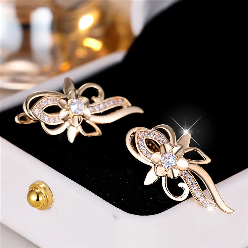Silver hoop earrings with flower-shaped design featuring sparkling zircon stones, crafted by Corporación Turística.