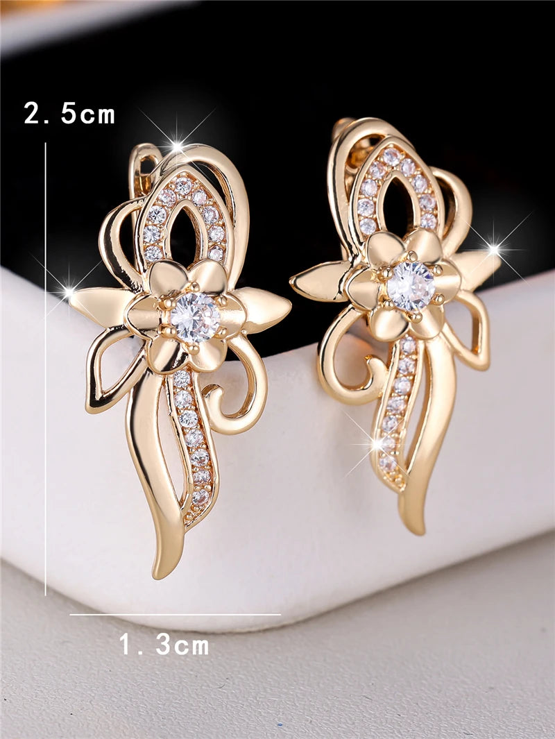 Silver hoop earrings with floral design and cubic zirconia stones, crafted by Corporación Turística.