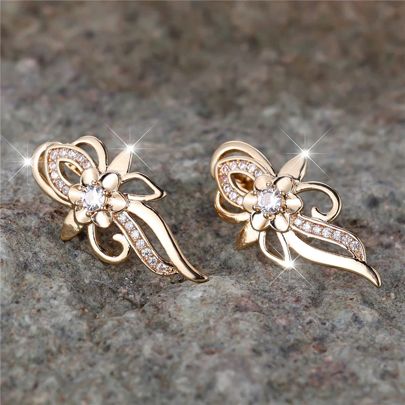 Gold-tone hoop earrings with floral design and sparkling zircon stones, showcasing elegant jewelry style.
