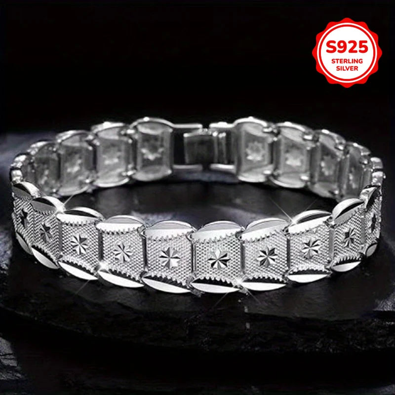 Elegant sterling silver bracelet with coin design from Corporación Turística, showcasing intricate craftsmanship on a stylish accessory.