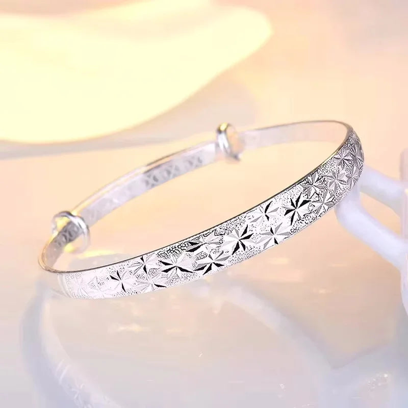 Romantic silver bracelets made of 925 sterling silver, featuring original designs, displayed on a neutral background.