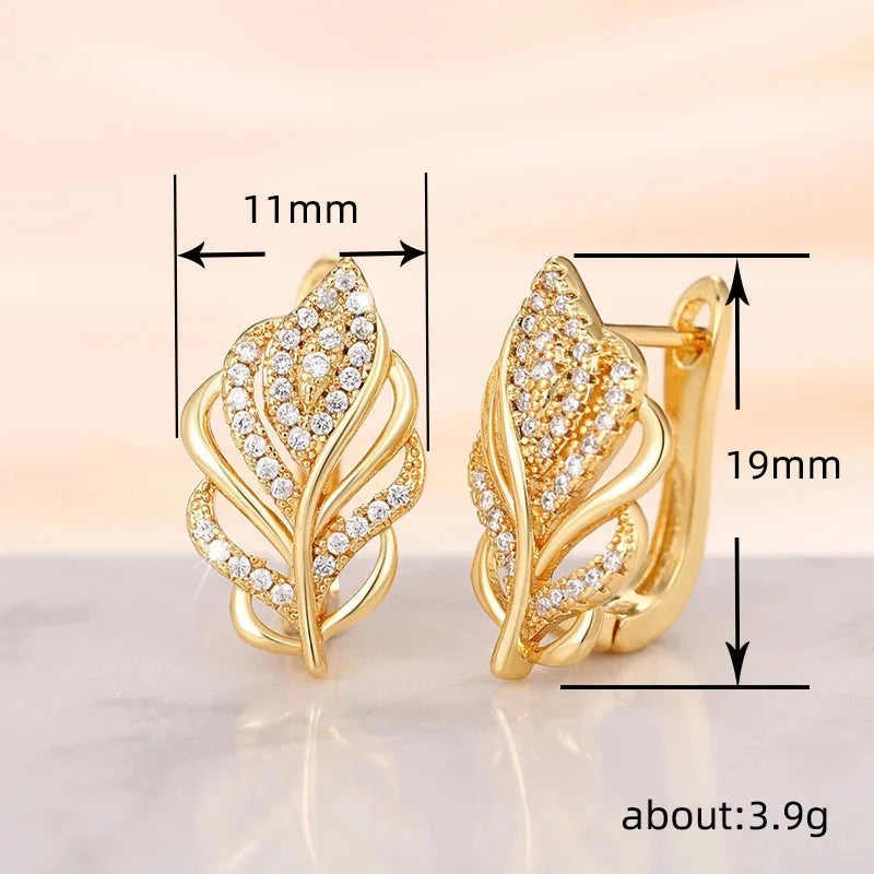 Huitan leaf-shaped hoop earrings from Corporación Turística, silver-tone jewelry with intricate leaf design.