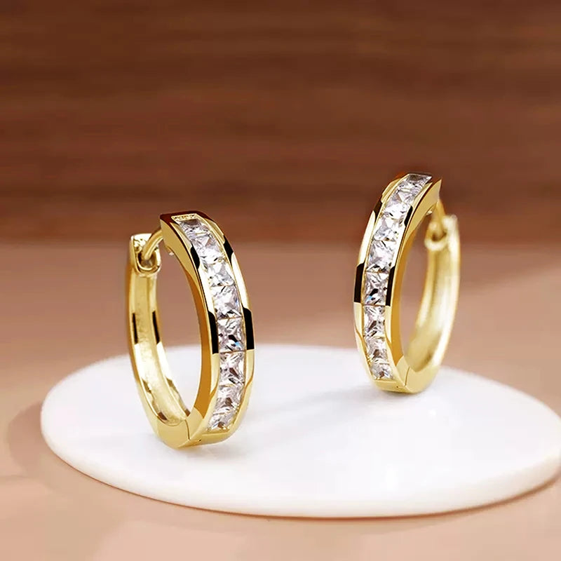 Classic hoop earrings for women by Corporación Turística, featuring a simple and elegant circular design.