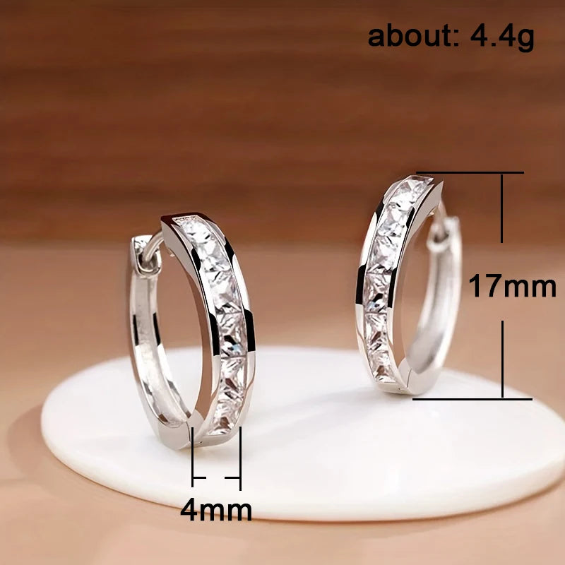 Gold hoop earrings for women featuring a classic design, crafted by Corporación Turística, shown on a white background.