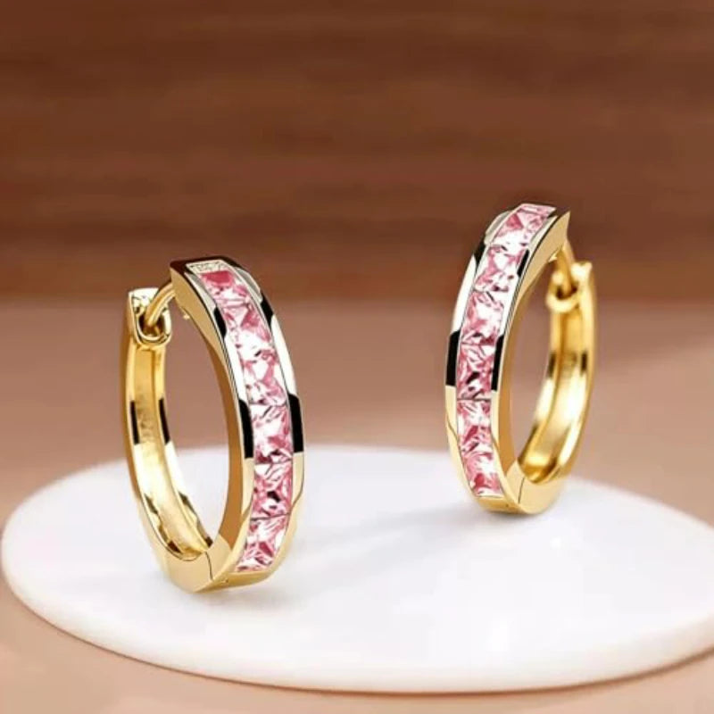 Gold hoop earrings with a classic design for women, featuring a simple and elegant style.