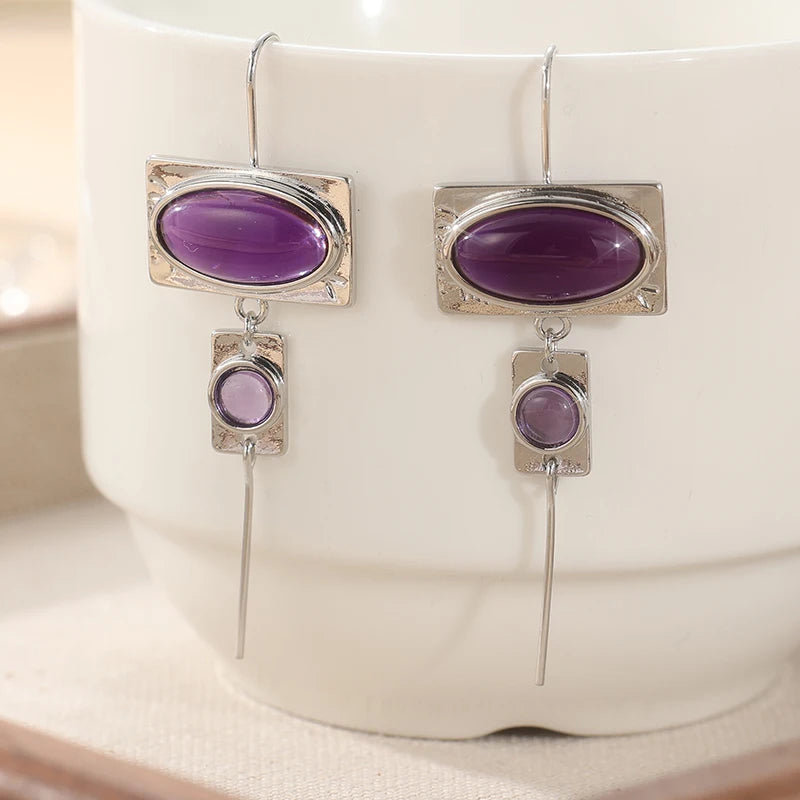 Vintage oval design earrings with intricate inlay details, crafted by Corporación Turística.