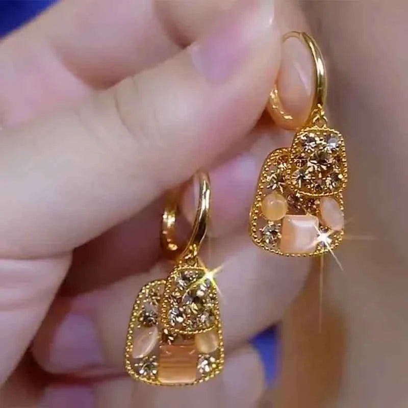Square crystal zirconia earrings in warm brown from Corporación Turística, featuring sparkling gemstone accents and modern design.
