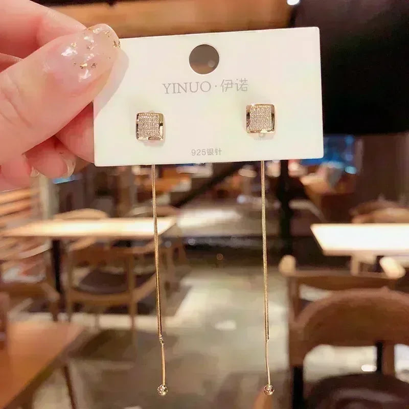 Elegant square crystal zirconia earrings by Corporación Turística featuring brown stones and a sleek, modern design.