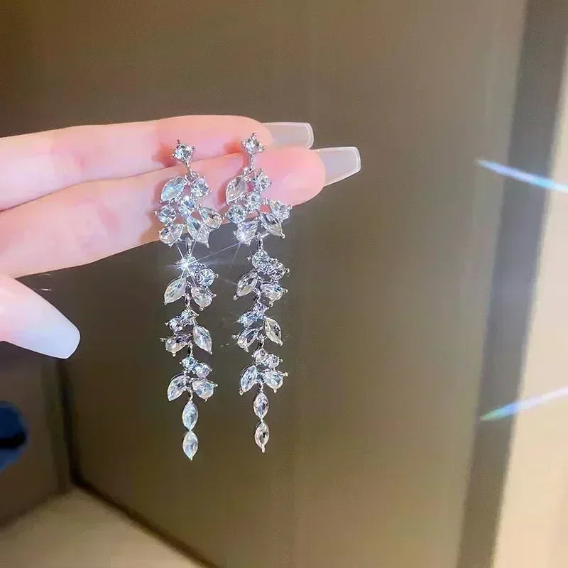 Elegant crystal drop earrings in teardrop shape with silver hooks, showcasing sparkling clear crystals for a sophisticated look.