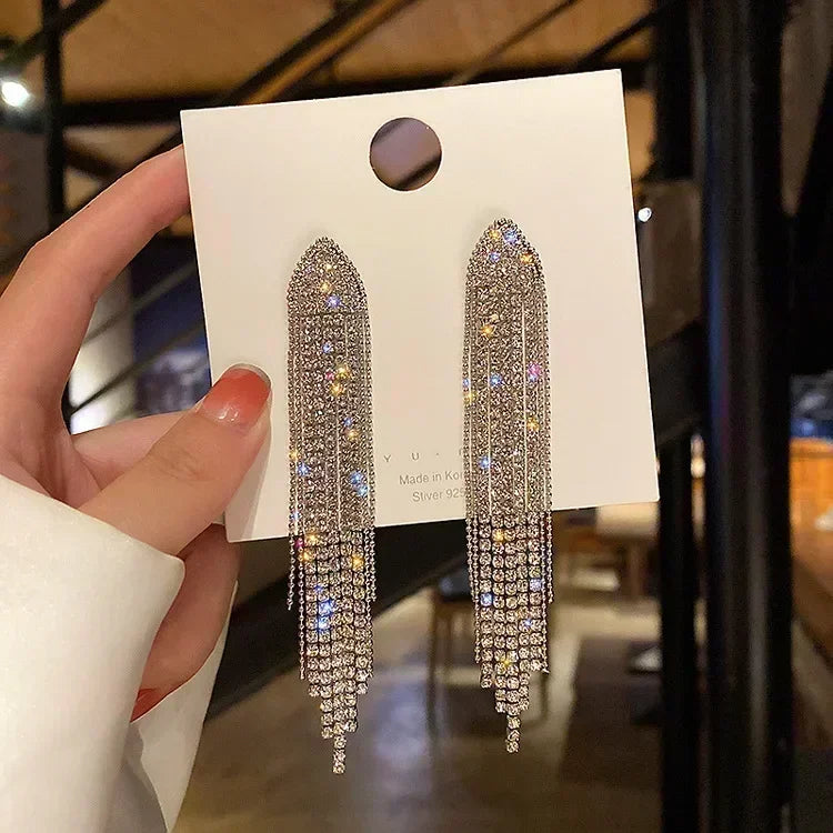 Elegant crystal drop earrings in a teardrop shape by Corporación Turística, featuring clear, sparkling crystal pendants.