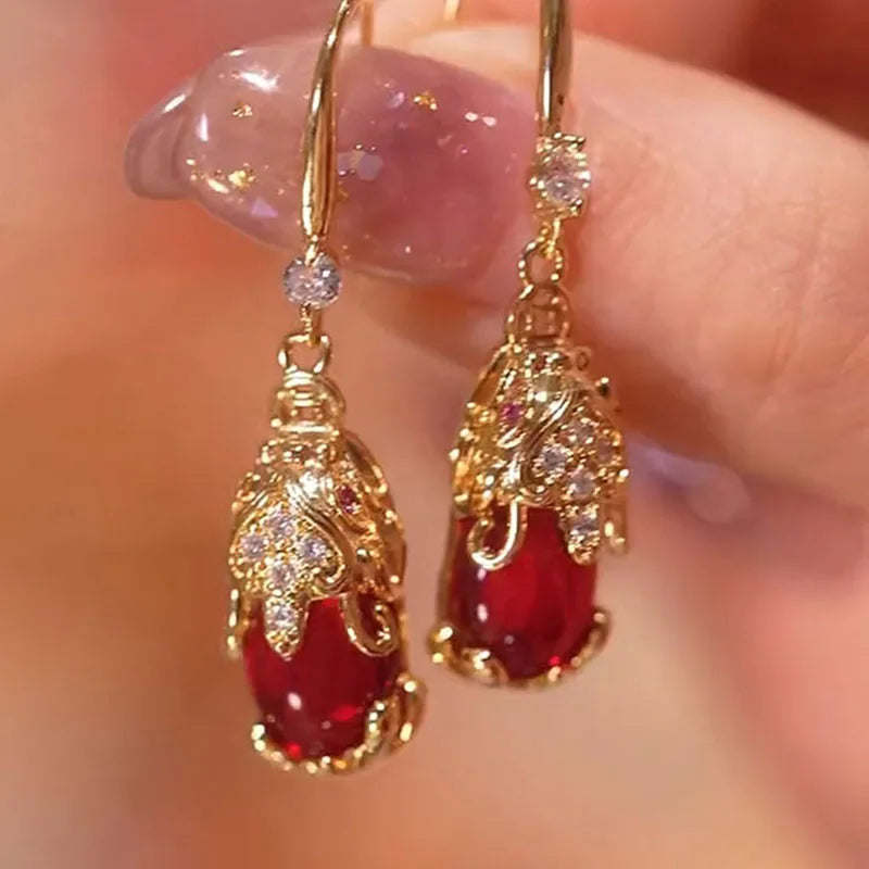 Red Pixiu retro fashion earrings for women, showcasing bold, intricate design with vibrant color, by Corporación Turística.