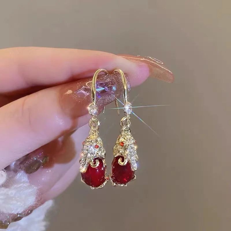 Red retro Pixiu earrings for women, stylish Fashicn jewelry by Corporación Turística, featuring intricate design and bold color.