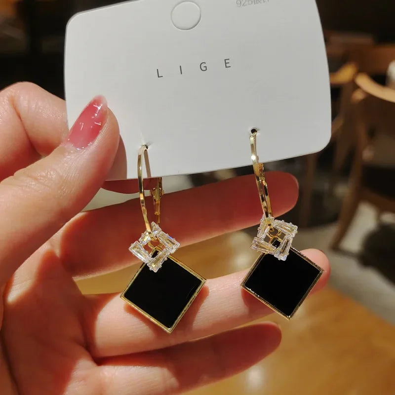 Red Retro Pixiu earrings for women, stylish fashion jewelry by Corporación Turística, featuring intricate design and vibrant color.