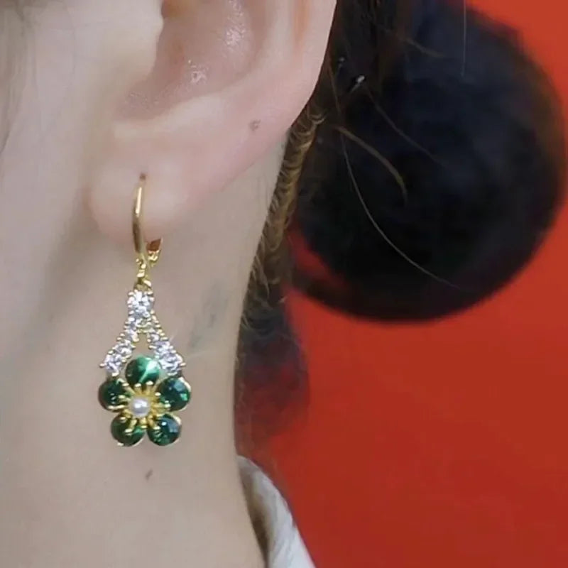 Luxury green crystal flower earrings from Corporación Turística, elegant jewelry with intricate floral design.