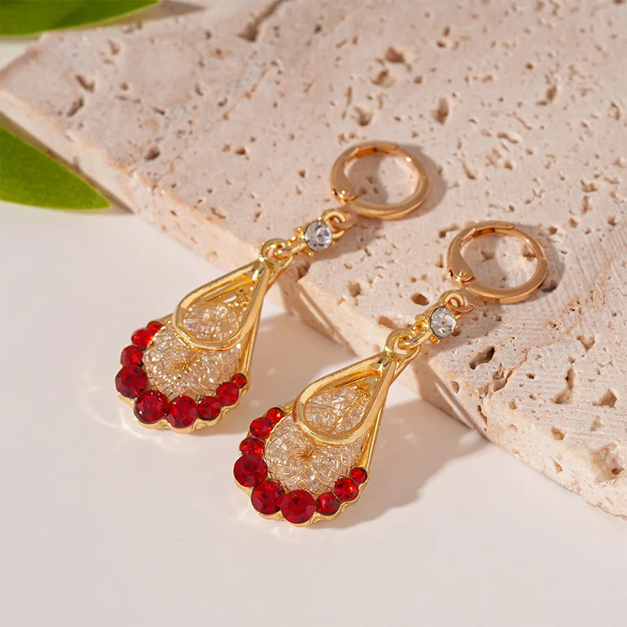 Long crystal drop tassel earrings with beaded fringe, stylish jewelry by Corporación Turística, visible dangling design and sparkling crystals.