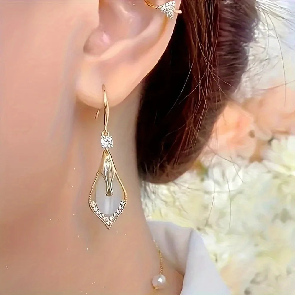 Exquisite cat's eye stone dangling earrings by Corporación Turística featuring smooth, polished gemstone pendants.