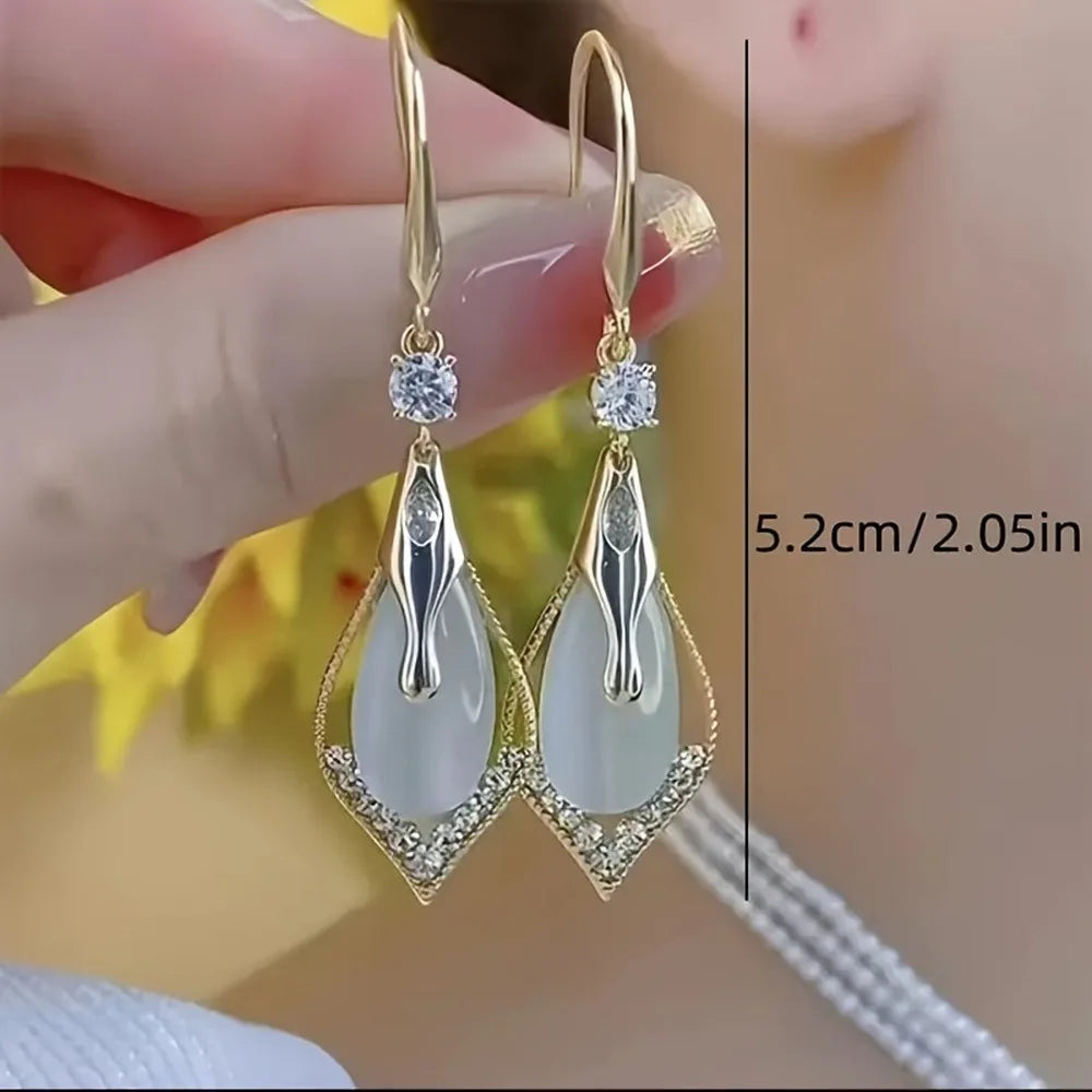 Exquisite cat's eye stone drop earrings by Corporación Turística, featuring polished, elegant hanging jewelry with vibrant gemstone details.