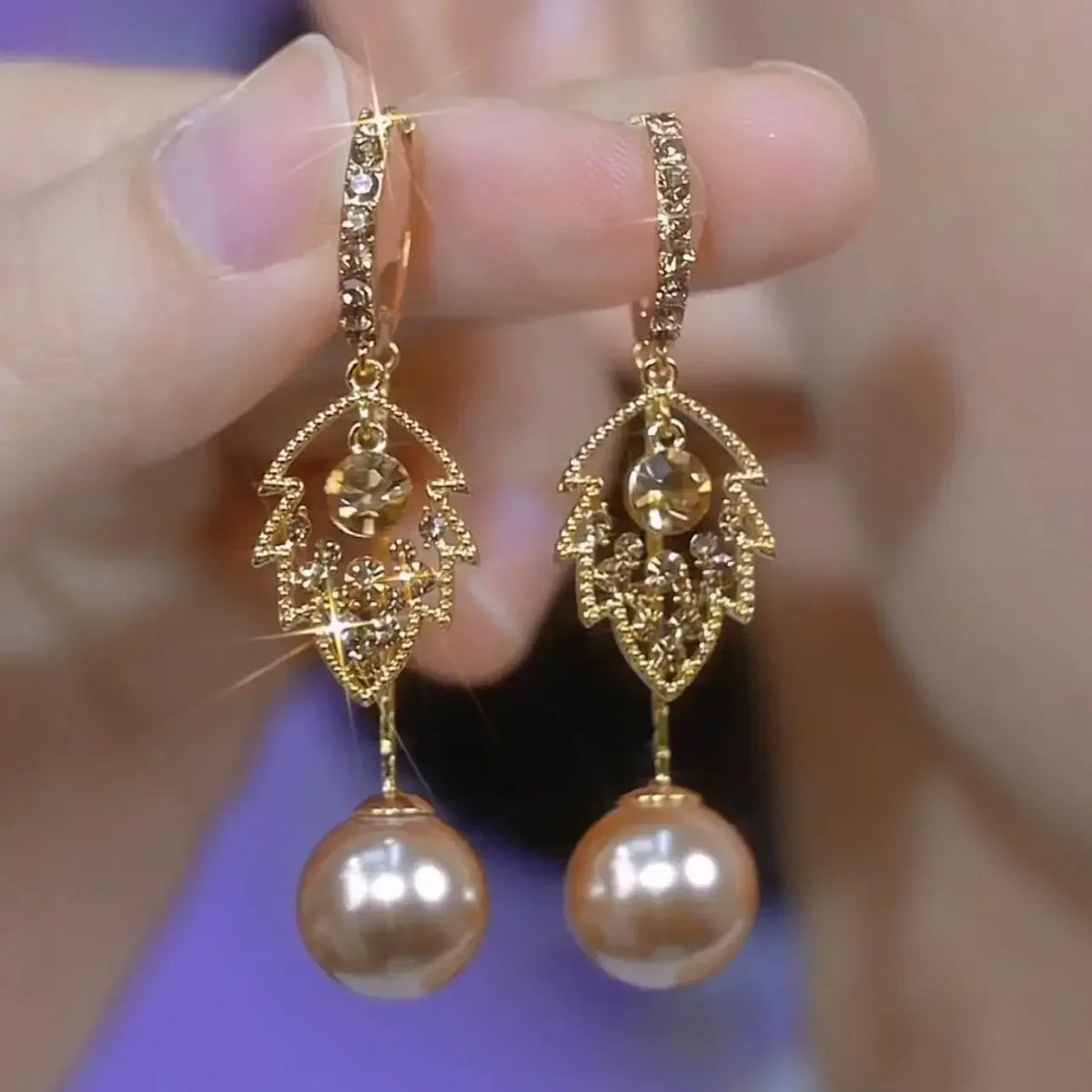 Exquisite cat's eye stone pendant earrings from Corporación Turística showcasing elegant dangling jewelry.
