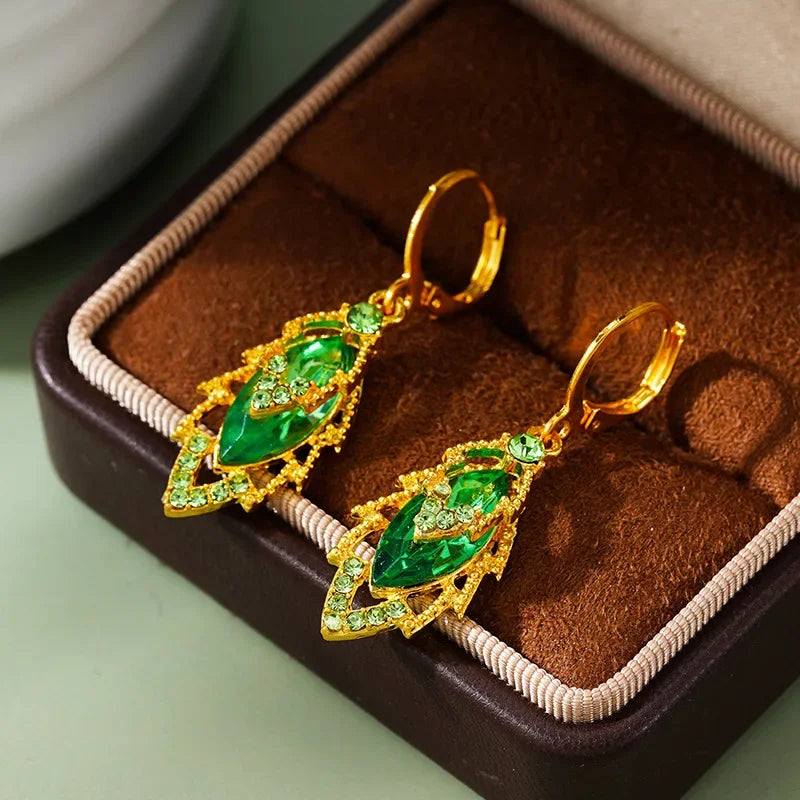Elegant crystal pendant earrings from Corporación Turística featuring intricate hanging design and sparkling circular crystal elements.