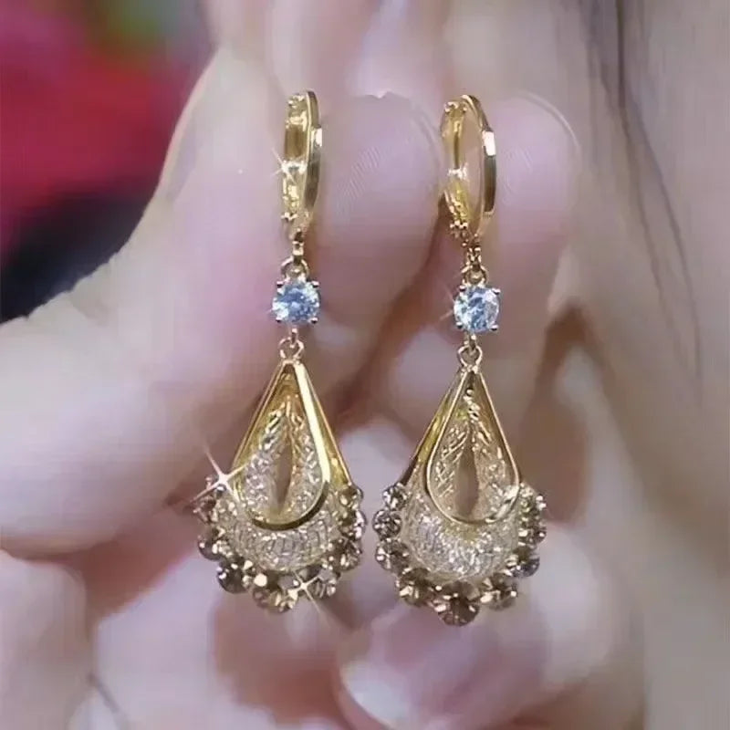 Elegant crystal pendant earrings featuring circular crystal drops, designed by Corporación Turística.