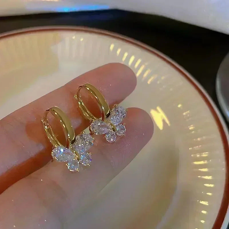 Gold leaf crystal earrings for women featuring green crystal leaves, stylish jewelry by Corporación Turística.