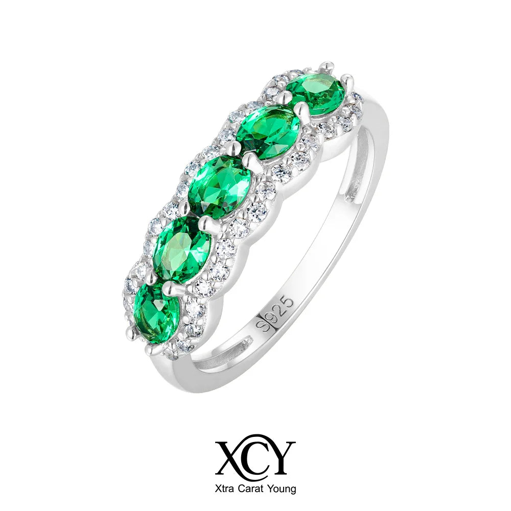 Oval-shaped XCY ring with simulated emerald for women, featuring white gold plating and elegant design.