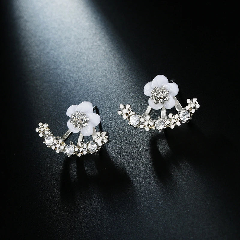 Silver floral earrings from Corporación Turística featuring delicate flower designs, stylish jewelry for women.