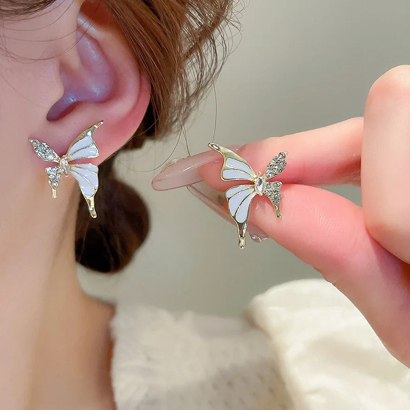 Elegant butterfly-shaped fashion earrings for women featuring colorful design, crafted by Corporación Turística.