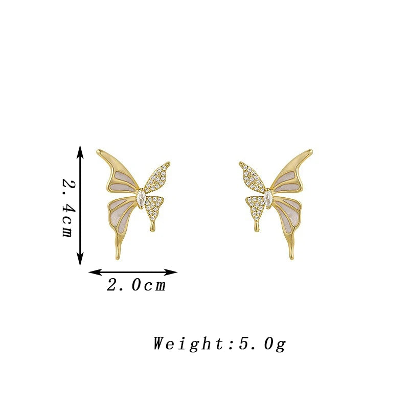 Elegant butterfly-shaped fashion earrings for women, featuring intricate design and vibrant colors, by Corporación Turística.