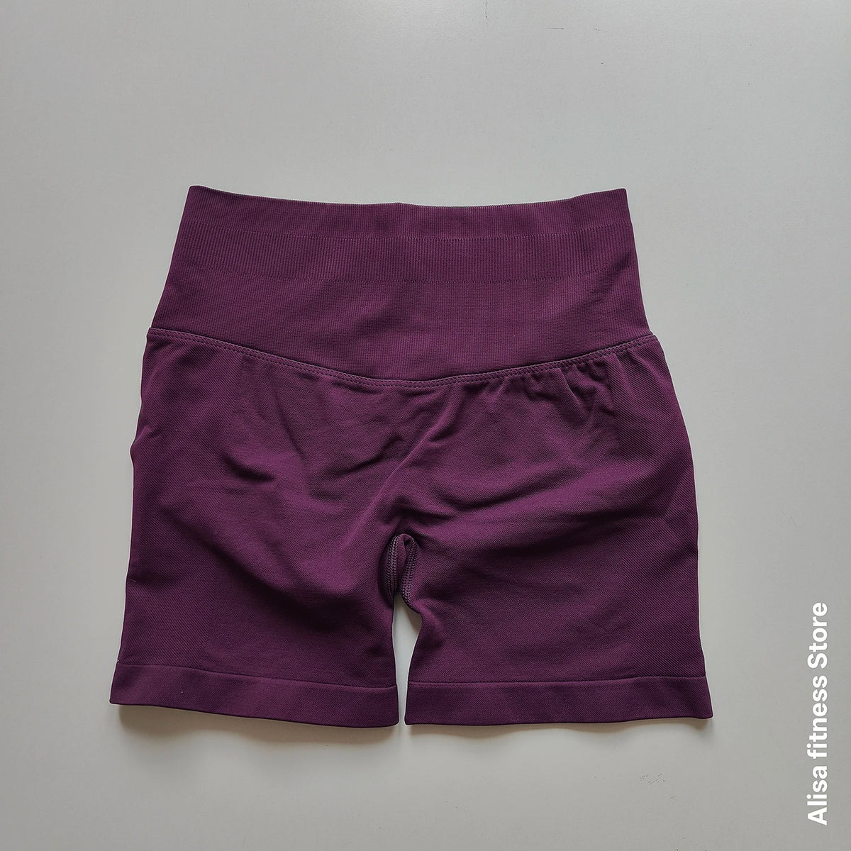 Dark gray high-waisted yoga shorts by Corporación Turística, seamless summer activewear for women, shown on a model.